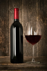 Bottle of red wine and glass