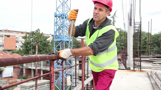 Construction Worker With Ratchet Wrench in Action.