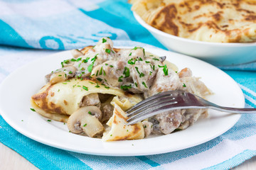 Russian pancakes with chicken and mushrooms champignon