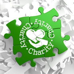 Charity Concept on Green Puzzle Pieces.