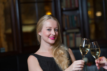 Beautiful happy woman celebrating with champagne