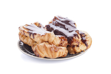 Eclairs with cream in chocolate coating isolated on white