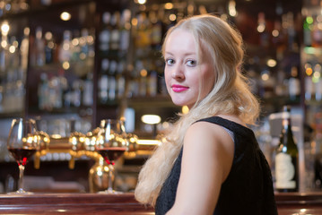 Beautiful woman seated at a bar counter