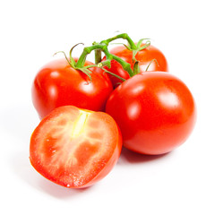Closeup of tomatoes on the vine isolated on white.