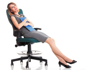 Full length business woman sitting on chair holding clipboard is