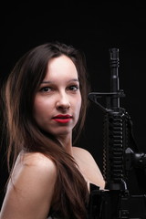 Fototapeta na wymiar Girl holding Rifle on black background