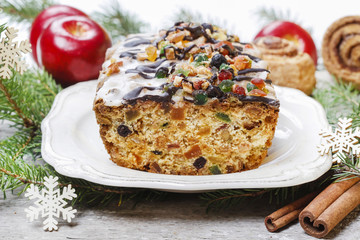 Fruitcake with dried fruits and nuts in christmas setting