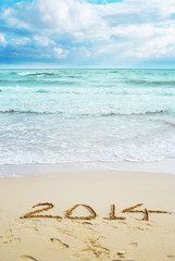 Fototapeta na wymiar Beautiful view on the beach with 2014 year signs