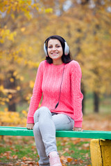 Portrait of a woman at outdoor with headphones.