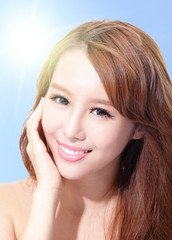 Fototapeta premium Beautiful woman face with sunshine and sky