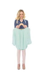 Smiling gorgeous fashion designer holding blouse