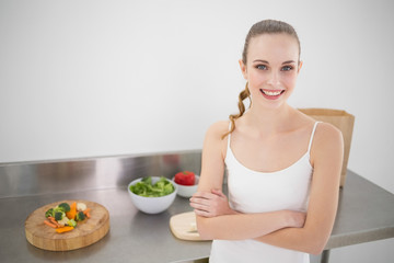 Happy young woman standing by her counter