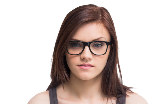 Serious young woman wearing glasses posing