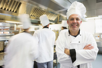 Head chef posing proudly in kitchen