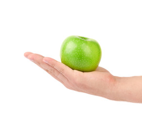 Hand holds green apple.