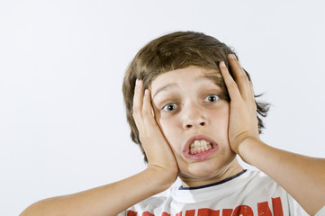 fearful grimacing of boy on white
