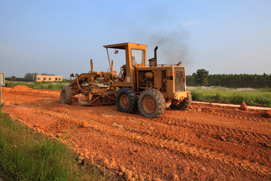 heavy grader machine vehicle working on road construction site