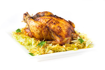 Roasted whole chicken with crust and garnish of stewed cabbage