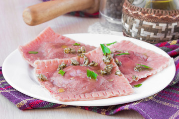 Italian pink pasta ravioli with beet filling