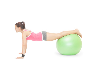 Fototapeta na wymiar Content sporty brunette doing exercise with exercise ball
