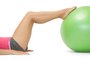 Close up of female legs with exercise ball