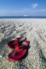 Pair of flip-flops on a beach