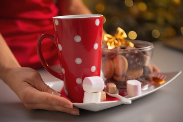 Closeup on plate with christmas cookies and cup of hot chocolate