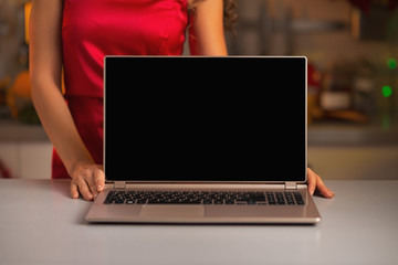 Fototapeta premium Closeup on laptop blank screen showing by woman in red dress 