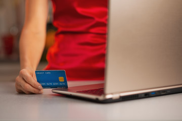 Closeup on credit card in hand of woman making online purchases