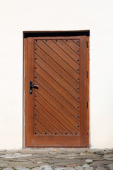 entrance wooden door on white wall