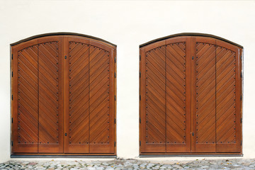 two wooden entrance gate on white wall