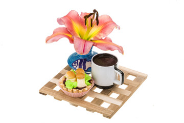 Coffee with cupcake and lilly flower
