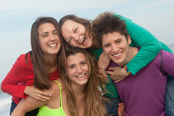 group of happy youth at the beach