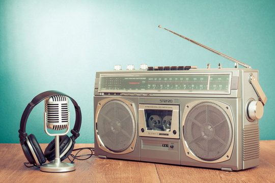 Retro radio and cassette player, headphones, microphone on table