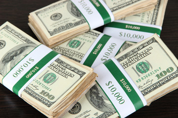 Stacks of money on wooden table