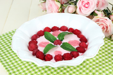 Sweet cream soup with fresh raspberry and sour cheese,