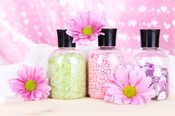 Obraz na płótnie Canvas Aromatherapy minerals - colorful bath salt on pink background