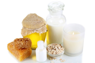 Honey and milk spa with oils and honey isolated on white