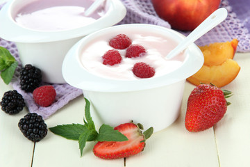 Delicious yogurt with fruit and berries on table close-up