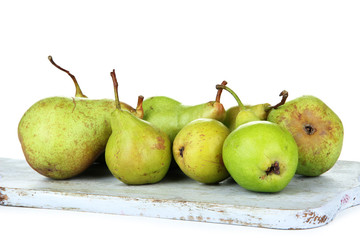Pears on wooden cutting board, isolated on white