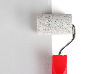 Obraz premium Roller brush with grey paint closeup