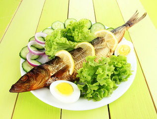 Smoked fish on plate close up