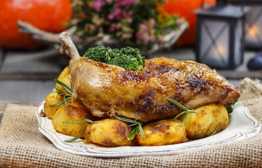 Roasted chicken with vegetables on wooden table