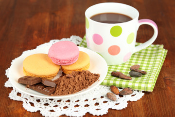 Cocoa in cup with sweets and cocoa powder