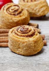 Cinnamon rolls on rustic rough wooden table