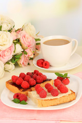 Delicious toast with raspberries on table on light background