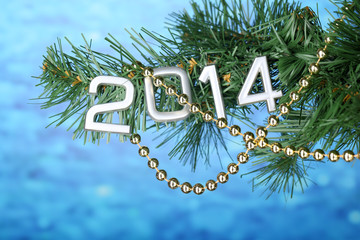 2014 hang on Christmas tree close-up on blue background
