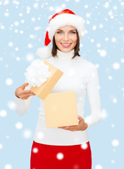 smiling woman in santa helper hat with gift box