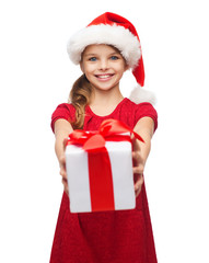 smiling girl in santa helper hat with gift box