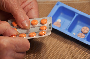 Hands of an elderly woman and tablets